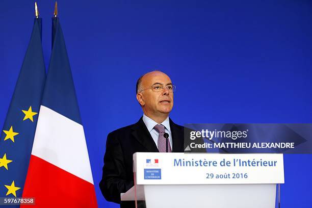 French Minister of Interior Bernard Cazeneuve delivers a speech during a press conference following a meeting with representatives of the Islamic...