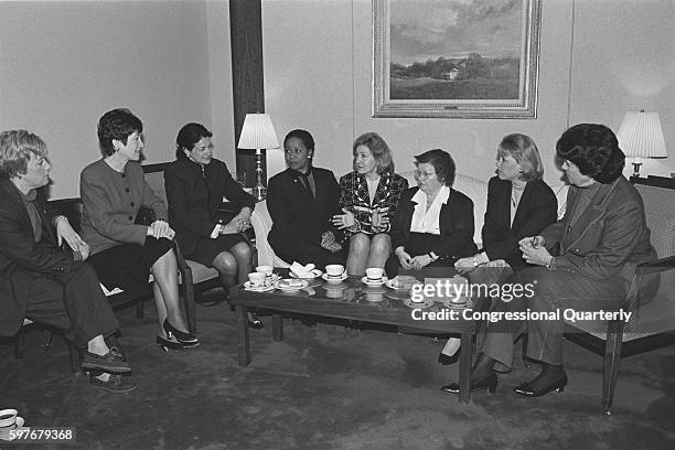 Women senators seated around a coffee table : Barbara Boxer, Susan Collins, Olympia Snowe, Carol Moseley-Braun, Kay Bailey Hutchison, Barbara...