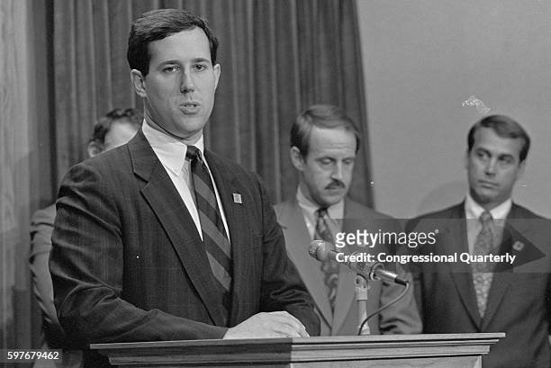 Representative Rick Santorum, R-Pa., stands at a podium with Representatives John Boehner and Frank Riggs in September 1991.