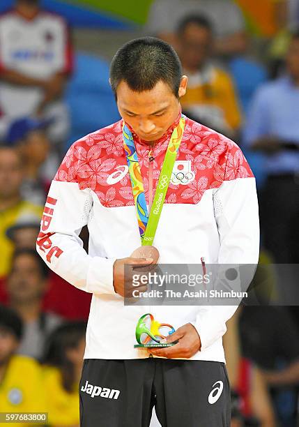 Bronze medalist Masashi Ebinuma of Japan stands on the podium at the medal ceremony for the Men's -66kg on Day 2 of the Rio 2016 Olympic Games at...