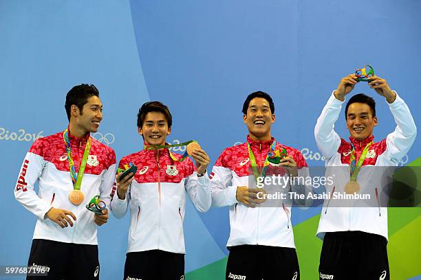 Bronze medalists Kosuke Hagino, Naito Ehara, Yuki Kobori and Takeshi Matsuda of Japan pose on the podium at the medal ceremony for the Men's 4x200m...