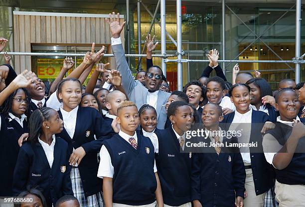 Sean "Diddy" Combs and children from Capital Prep Harlem Charter School attend the Sean "Diddy" Combs Charter School opening at Capital Preparatory...