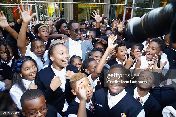 Sean "Diddy" Combs and children from Capital Prep Harlem Charter School attend the Sean "Diddy" Combs Charter School opening at Capital Preparatory...