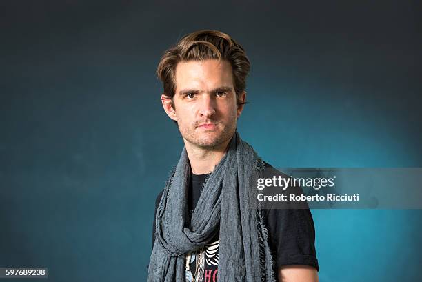 Novelist and English rock musician Chris Russell attends a photocall at Edinburgh International Book Festival at Charlotte Square Gardens on August...