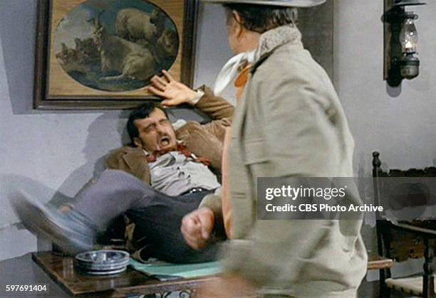 Theatrical movie originally released December 18, 1970. Film directed by Howard Hawks. Pictured left to right, Victor French , gets hit by John Wayne...
