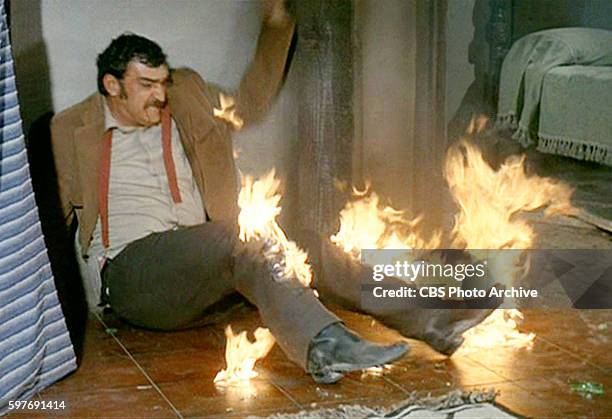 Theatrical movie originally released December 18, 1970. Film directed by Howard Hawks. Pictured, Victor French , with his legs on fire. Image is a...
