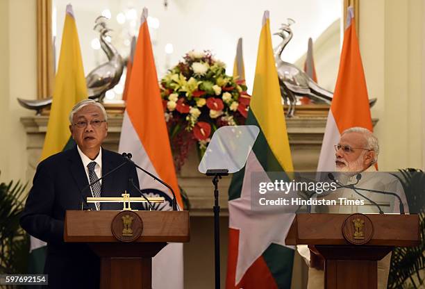President of the Republic of the Union of Myanmar U Htin Kyaw listens as Indian Prime Minister Narendra Modi delivers a statement after signing an...