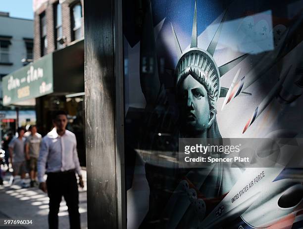 Picture of the Statue of Liberty is displayed on a phone booth in the ethnically diverse neighborhood of Queens on August 29, 2016 in New York City....