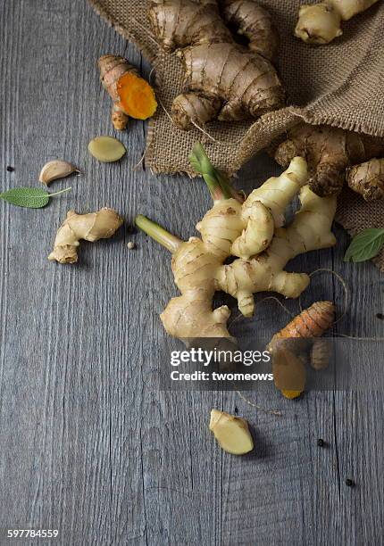 ginger and turmeric on wooden background. - ginger fotografías e imágenes de stock