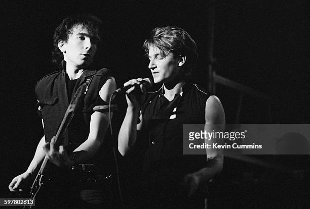 Singer Bono and guitarist The Edge performing with Irish rock group U2, at the Apollo, Manchester, December 1982.