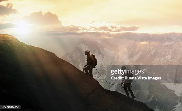 climbers on a mountain ridge - 壮大な景観 ストックフォトと画像