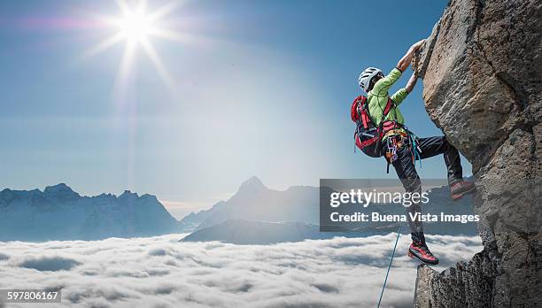 climber on a rocky wall - climbing a mountain stock pictures, royalty-free photos & images