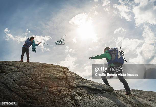 couple of climbers in the mountains - throwing rocks stock pictures, royalty-free photos & images