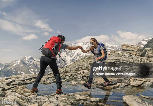 a couple trekking in the mountains - monte rosa fotografías e imágenes de stock