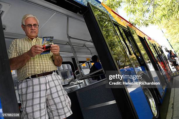 John Everton checks out the new 16th Street Free MallRide bus on display at Skyline Park on the 16th street mall on August 29, 2016 in Denver,...