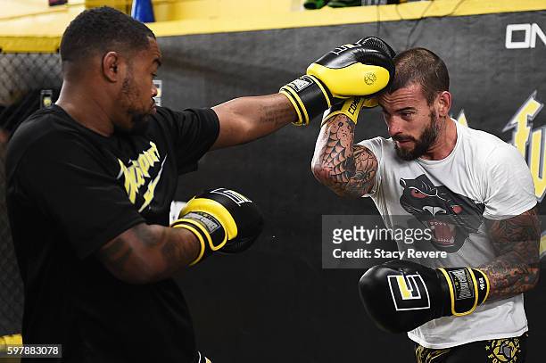 Punk spars with Mike "Biggie" Rhodes during a training session at Roufusport Martial Arts Academy on August 29, 2016 in Milwaukee, Wisconsin.
