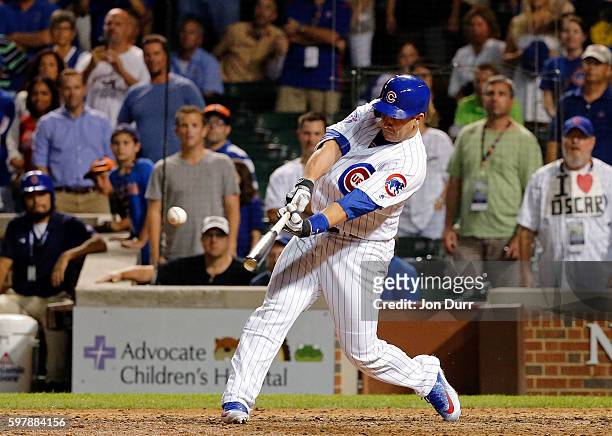 Miguel Montero of the Chicago Cubs hits a walkoff RBI single against the Pittsburgh Pirates during the thirteenth inning at Wrigley Field on August...