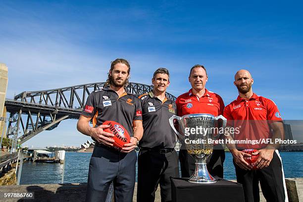 Callan Ward and Leon Cameron of the Giants along with John Longmire and Jarrad McVeigh of the Swans pose for a photo with the 2016 AFL Premiership...