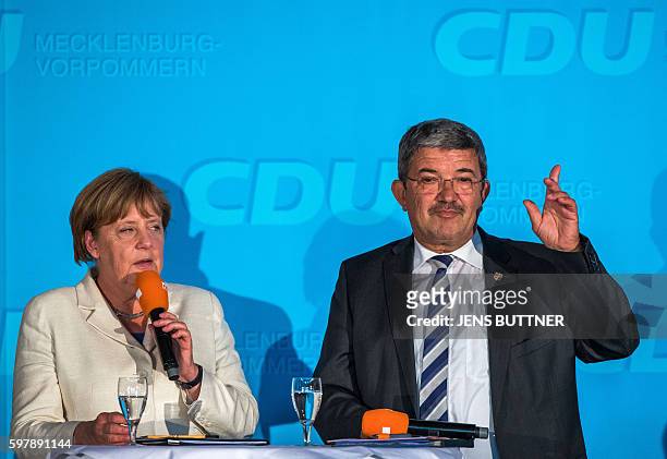 German Chancellor Angela Merkel and Mecklenburg-Western Pomerania's Interior Minister Lorenz Caffier, also top candidate of Merkel's Christian...