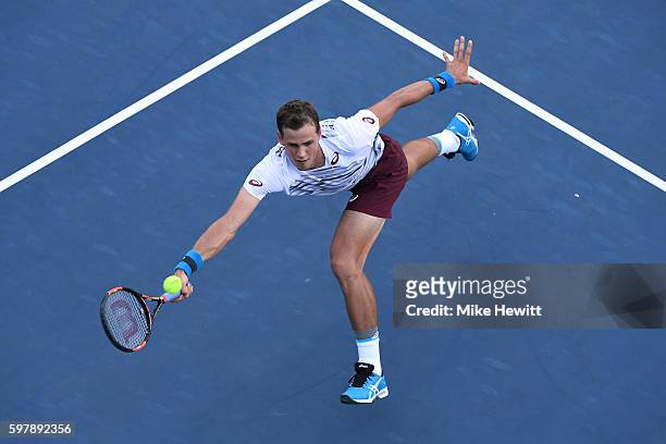 Vasek Pospisil of Canada returns a shot to Jozef Kovalik of Slovakia during his first round Men's Singles match on Day One of the 2016 US Open at the...