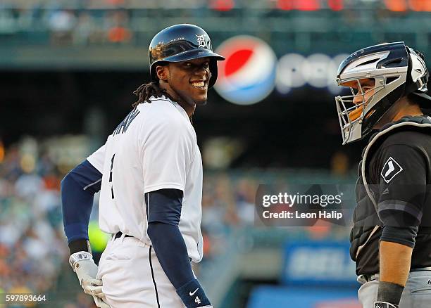 Cameron Maybin of the Detroit Tigers reacts after getting hit by a pitch as Alex Avila of the Chicago White Sox looks on during the first inning of...