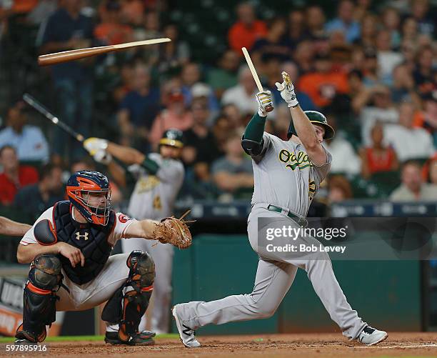 Max Muncy of the Oakland Athletics shatters his bat as he hits into a double play in the third inning against the Houston Astros at Minute Maid Park...