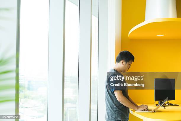 An employee uses a laptop computer at the Garena Interactive Holding Ltd. Headquarters in Singapore, on Thursday, Aug. 25, 2016. Garena, a gaming and...