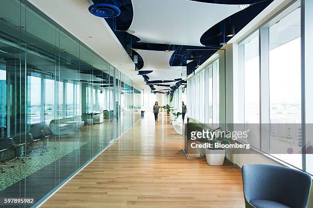 An employee walks through a corridor at the Garena Interactive Holding Ltd. Headquarters in Singapore, on Thursday, Aug. 25, 2016. Garena, a gaming...