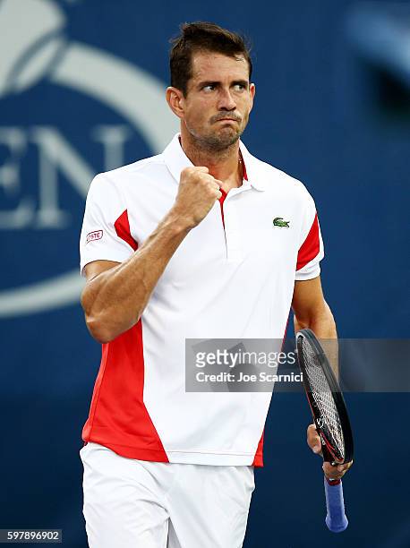 Guillermo Garcia-Lopez of Spain reacts against Roberto Bautista Agut of Spain during his first round Men's Singles match on Day One of the 2016 US...