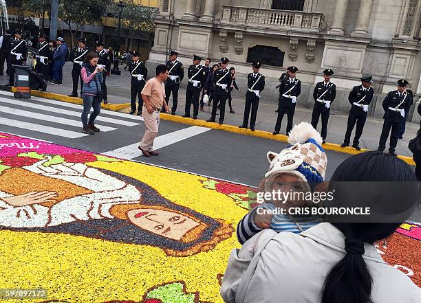 An image made with flower petals depicting Saint Rose of Lima, patron saint of the Peruvian capital, on an avenue on the eve of the saint's festivity...