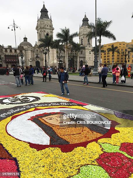 An image made with flower petals depicting Saint Rose of Lima, patron saint of the Peruvian capital, on an avenue on the eve of the saint's festivity...