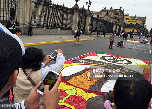 An image made with flower petals depicting Saint Rose of Lima, patron saint of the Peruvian capital, on an avenue on the eve of the saint's festivity...