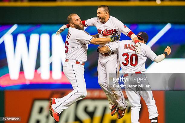 Mike Napoli and Tyler Naquin celebrate with Jason Kipnis of the Cleveland Indians after Kipnis hit a walk-off single to defeat the Minnesota Twins at...