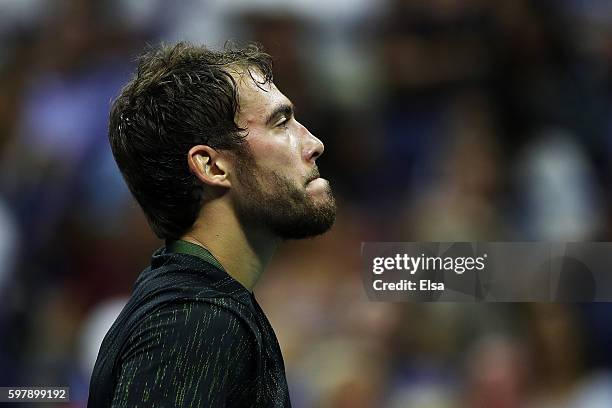 Jerzy Janowicz of Poland reacts against Novak Djokovic of Serbia & Montenegro during his first round Men's Singles match on Day One of the 2016 US...