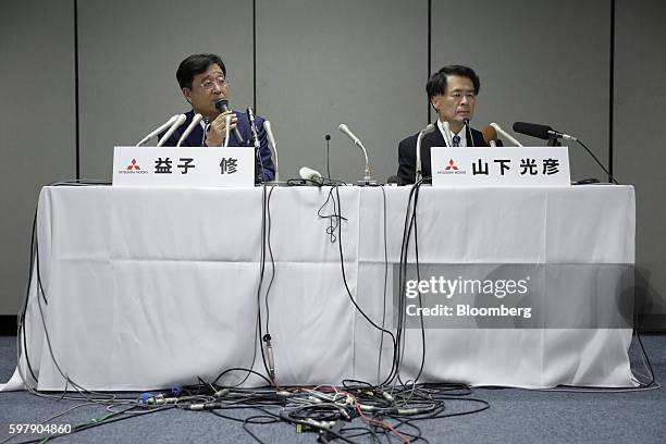 Osamu Masuko, chairman and chief executive officer of Mitsubishi Motors Corp., right, speaks as Mitsuhiko Yamashita, executive vice president of...