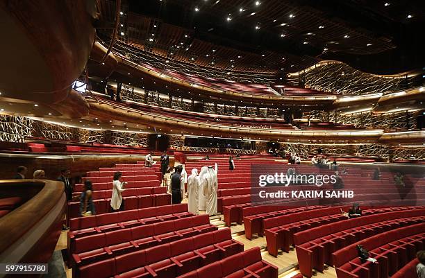 People visit Dubai's new opera house on the eve of its official opening on August 30, 2016 in the Gulf emirate. A boat-shaped hulk of steel and glass...