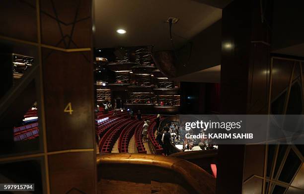 People visit Dubai's new opera house on the eve of its official opening on August 30, 2016 in the Gulf emirate. A boat-shaped hulk of steel and glass...