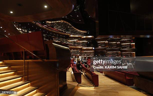 People visit Dubai's new opera house on the eve of its official opening on August 30, 2016 in the Gulf emirate. A boat-shaped hulk of steel and glass...