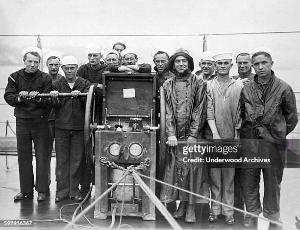 Divers and the pump crew aboard the battleship USS Pennsylvania as it rests at anchor in the Hudson River, New York, New York, April 15, 1919.