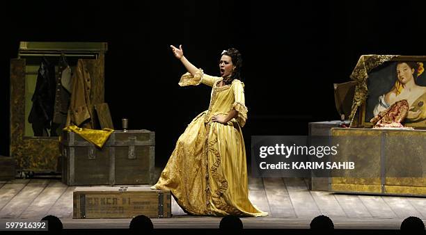 Singer performs on stage on August 30, 2016 during a dress rehearsal of Gioacchino Rossini's opera "The barber of Seville at Dubai's new opera house,...