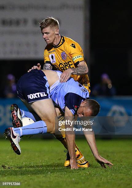 Matthew Jurman of Sydney and Andy Keogh of the Glory contest for the ball during the round 16 FFA Cup match between Perth Glory and Sydney FC at...