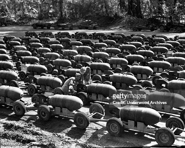 An array of two thousand pound bombs on trucks ready to be loaded onto Marine bomber planes during WWII operations in the Pacific theater,...