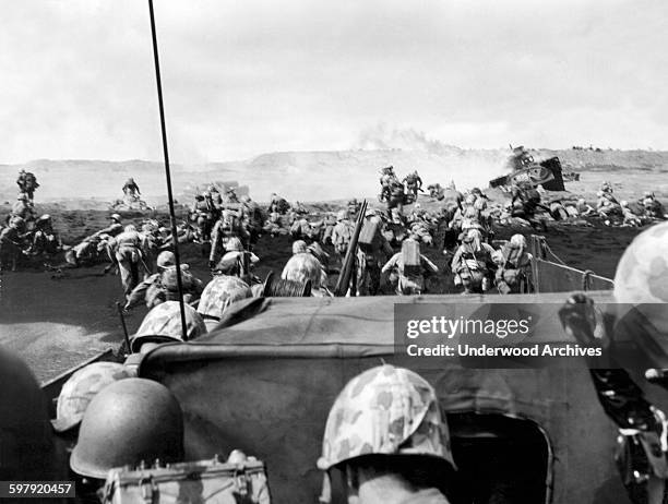 Fourth Division Marines charging from their landing craft onto the beach in the battle at Iwo Jima, Iwo Jima, Japan, March 2, 1945.
