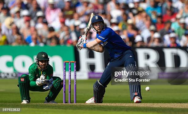 England batsman Alex Hales hits a ball for 6 runs watched by wicketkeeper Sarfraz Ahmed during the 3rd One Day International between England and...