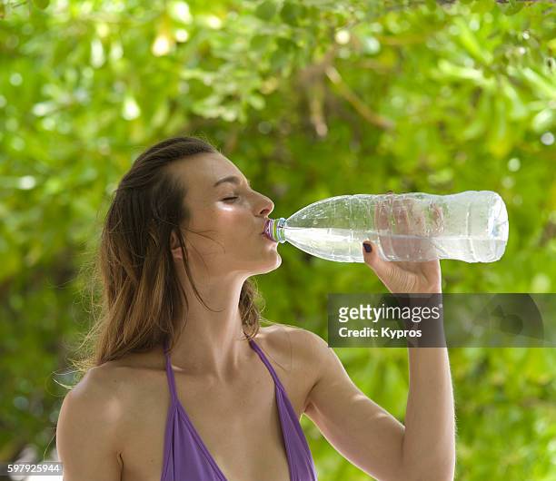 asia, maldives, young caucasian woman wearing bikini on tropical beach - running water isolated stock pictures, royalty-free photos & images