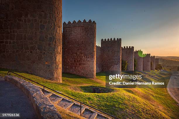 walls of avila at sunset. fortified building. fence surrounding the city - surrounding wall stock-fotos und bilder