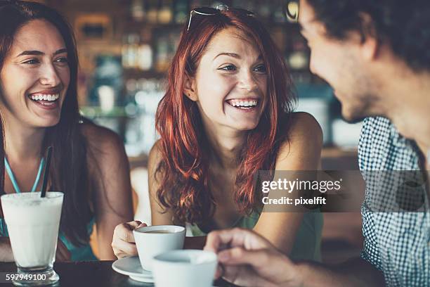 young people chatting in cafe - coffee shop couple stock pictures, royalty-free photos & images