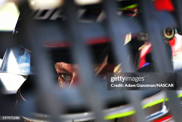 Eric Goodale driver of the GAF Roofing Chevrolet looks on from the garage area during practice prior to the Riverhead Raceway 200 at Riverhead...