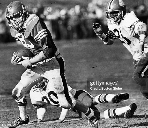 Waltham High School player Bob Qualters, left, runs past Brockton High School players Ron McMurtry and Tim Kelleher for the end zone after catching a...