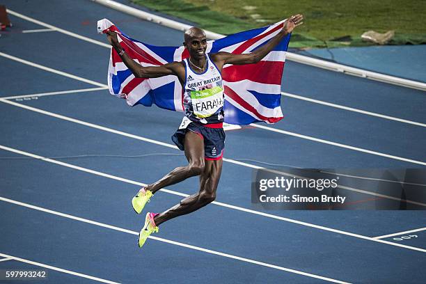 Summer Olympics: Great Britain Mohamed Farah victorious, holding up Great Britain flag after Men's 5000M Final at Maracana Stadium. Farah wins Gold....